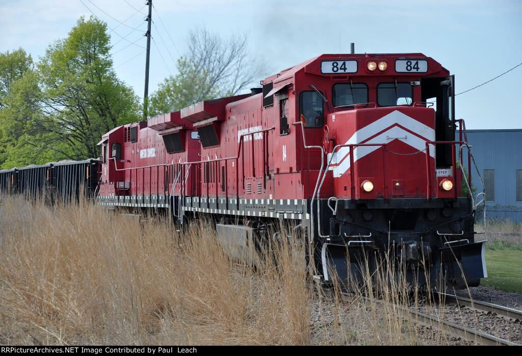 Northbound ballast train comes across the diamond